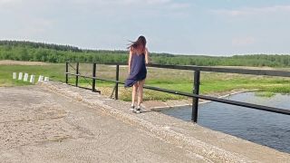 Brown-eyed exhibitionist walks naked on the bridge, flashing her tits and ass to passing cars below