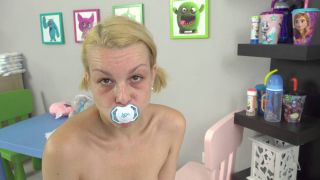 Blonde baby girl with blue eyes and blonde hair gets fucked by a big black cock while wearing tiny pink onesie