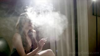 Abigail 1 smokes a cigarette while seducing her lover