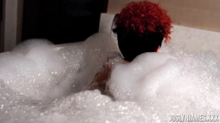 Joslyn James takes a soaking bath in the tub, her large breasts spilling out of her top as she strokes herself to orgasm