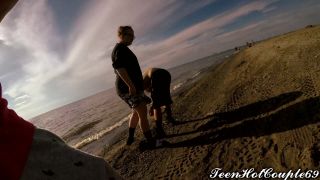 Watch as the couple fucks passionately on a public beach in America, with cum flying everywhere